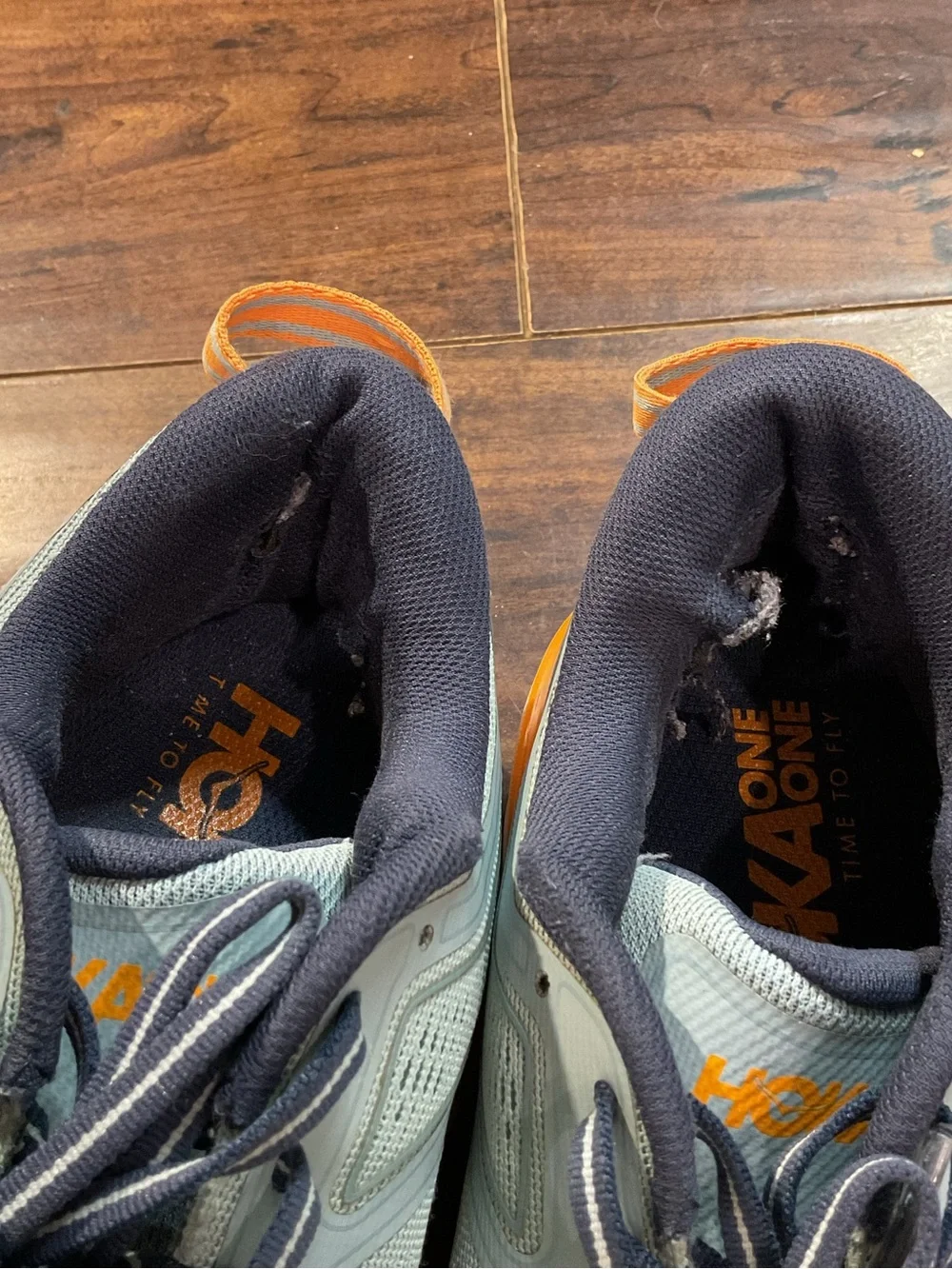 Hoka Blue Athletic Shoes with Orange and Pink Accents